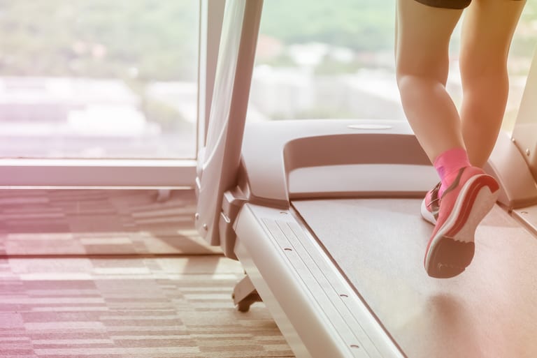 Woman wear pink go workout by running using treadmill
