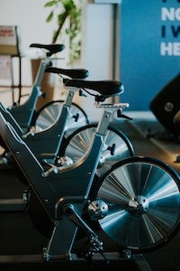 A row of spin bikes with flywheel at the back