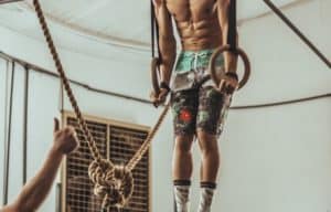 Man doing support hold showing gymnastic rings benefits