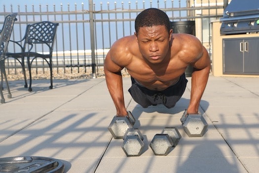 Man doing push-ups with dumbbells