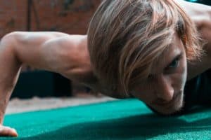 Man doing push-ups with intense look on his face