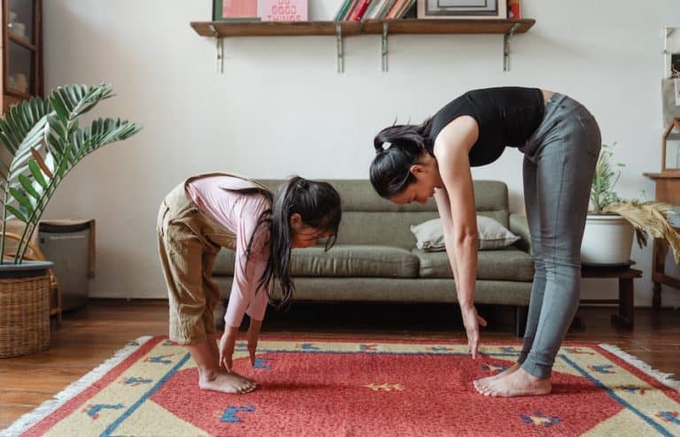 Mother and daughter showing ways to improve flexibility at home