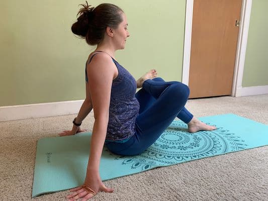 Author doing figure 4 yoga stretch to improve flexibility