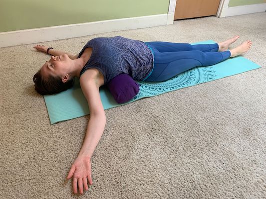 Author doing fish yoga stretch to improve flexibility