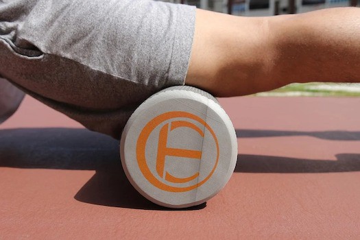 Man rolling out quadriceps on foam roller