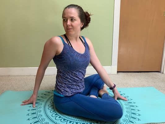 Author doing seated twist yoga stretch to improve flexibility