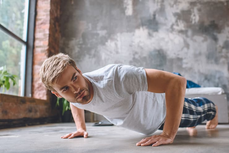 Man doing push ups at home in the morning calisthenics