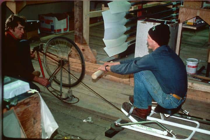 Photo showing two men testing a prototype rowing machine at the Concept2 barn circa 1976