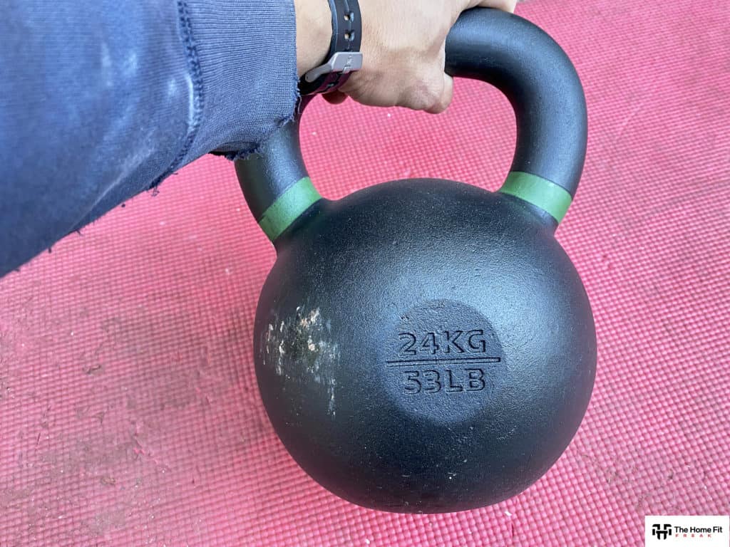 Man's hand holding a kettlebell