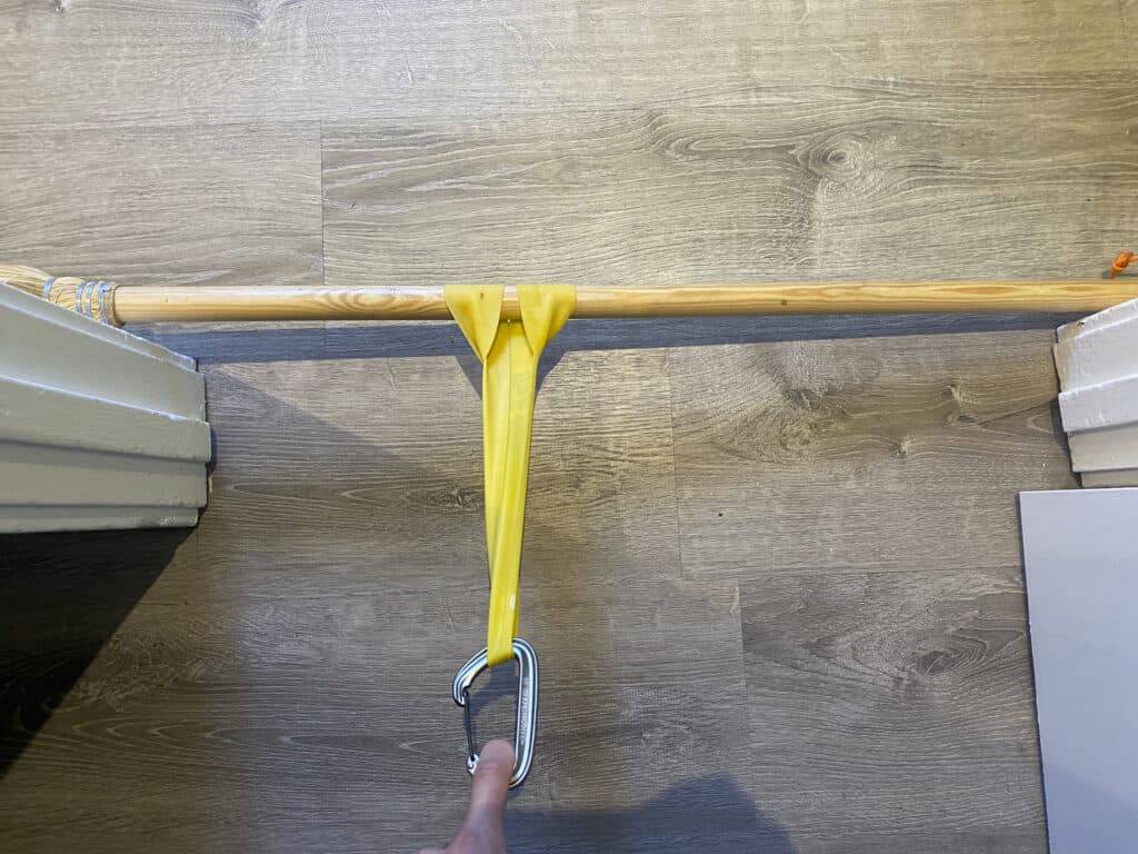 Exercise band attached to a broom across a doorway